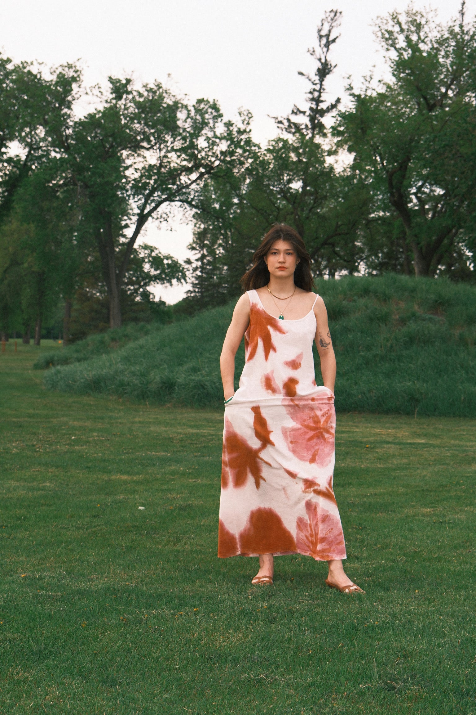 Model wearing Utku Hand Painted Floral Dress — hand-painted florals, unique to each piece dusky pink hibiscus 
