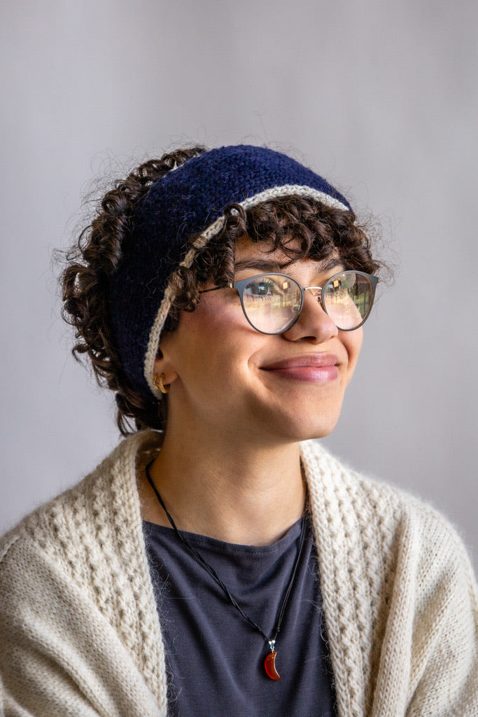 Model wearing Utku Knit Headband in Lyon blue — hand knitted in Ecuador