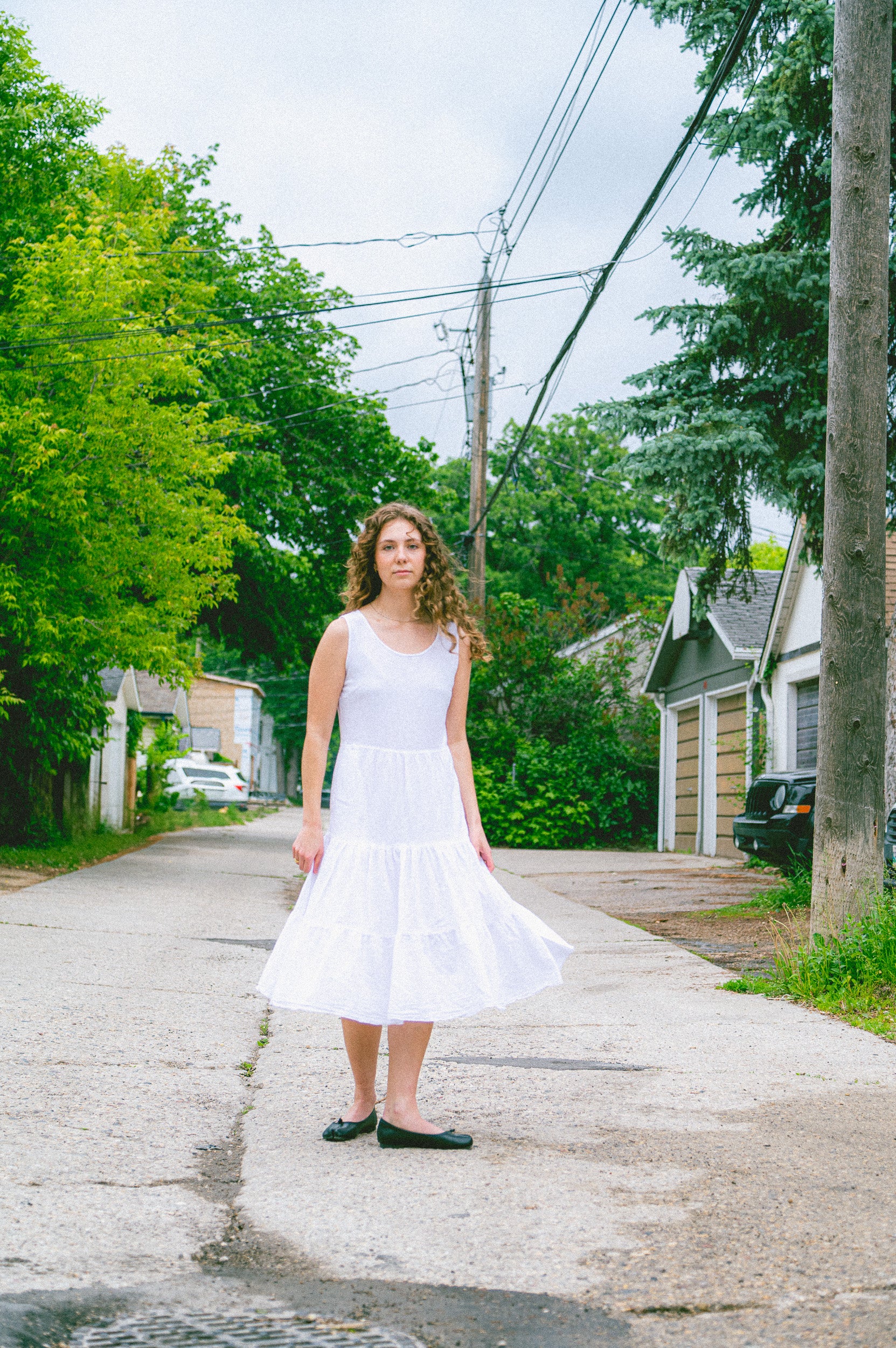 Model wearing Utku Tiered Dress in White — crinkle cotton
