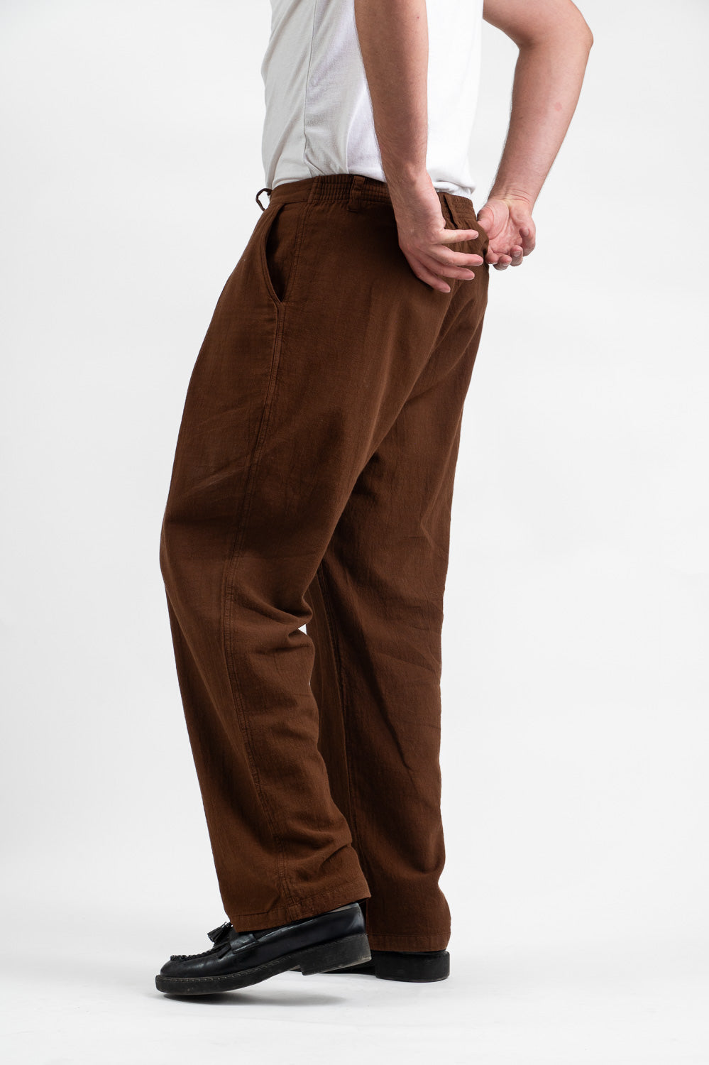 Model wearing Utku Pleated Pants in Tobacco Brown