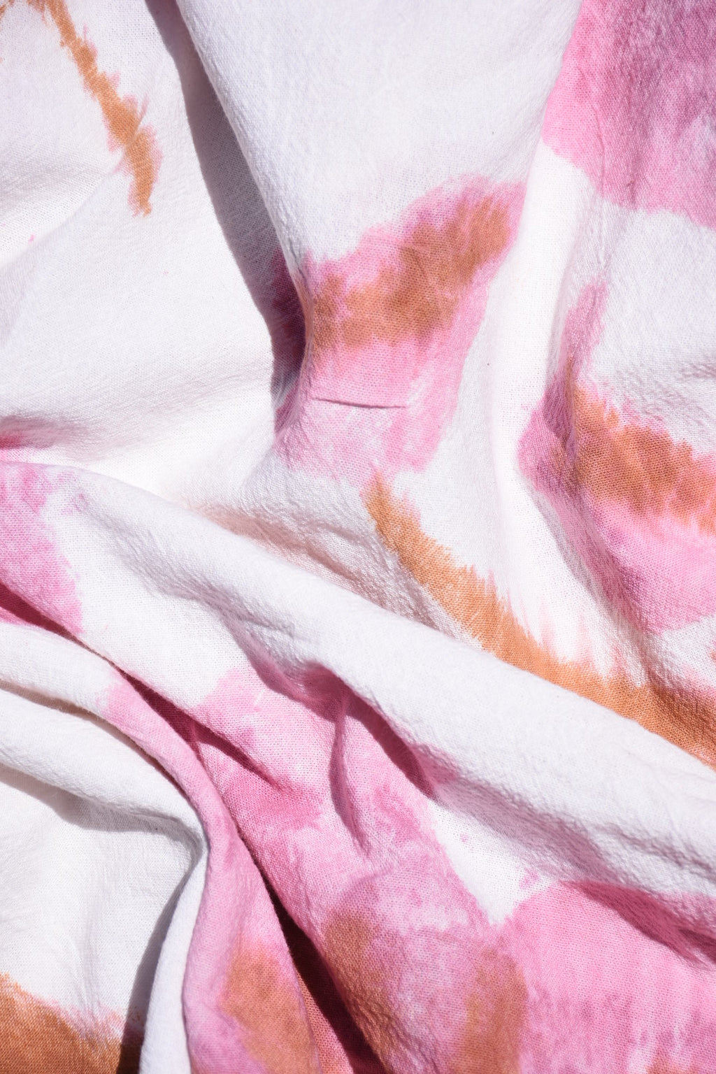 Close-up of fabric with pink and brown abstract pattern dusky pink hibiscus 