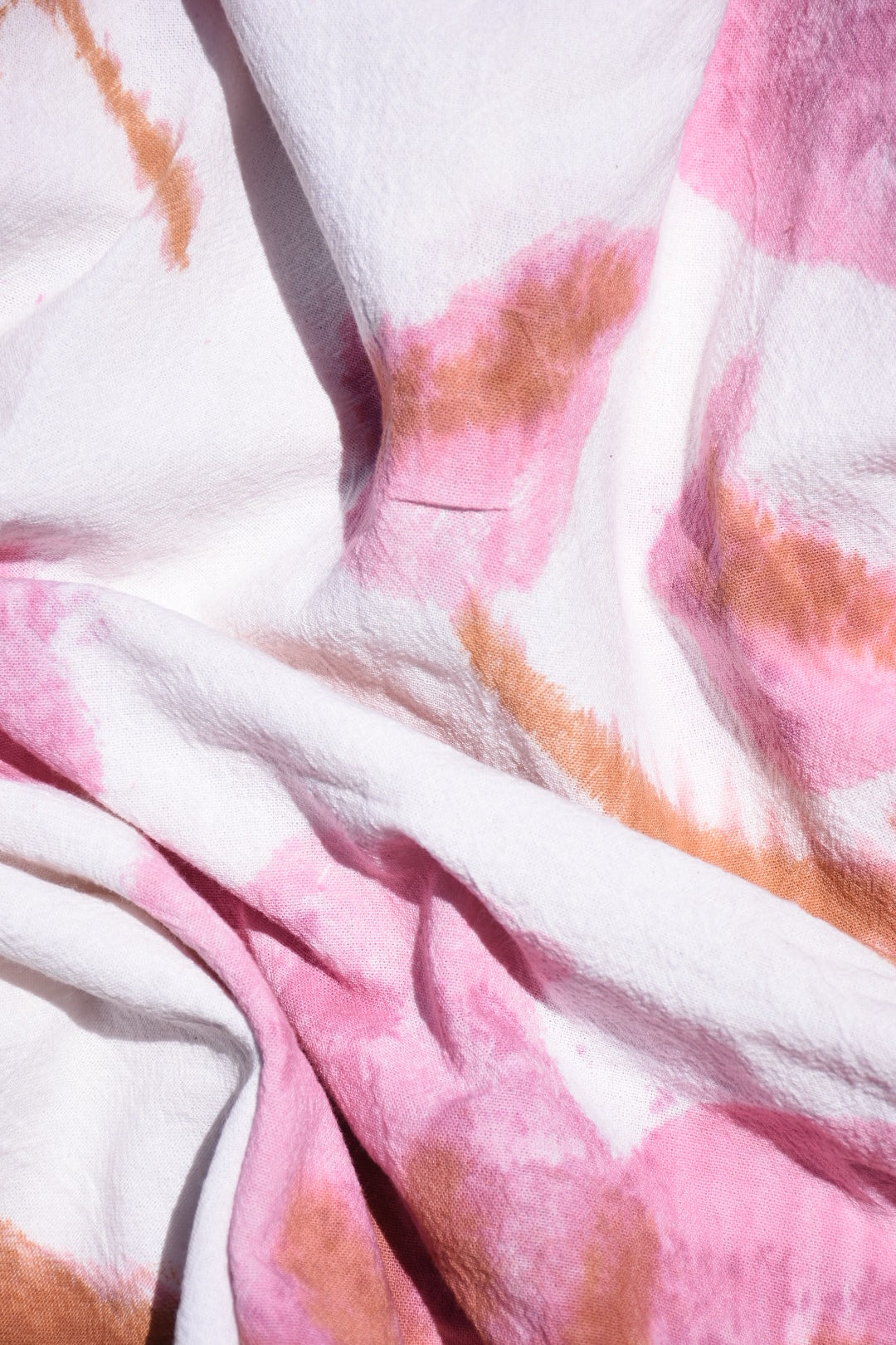 Close-up of fabric with pink and brown abstract pattern dusky pink hibiscus 