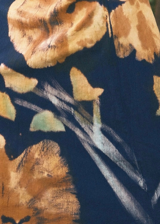 Close-up of a fabric with brown floral pattern on a dark background 
Azure Hibiscus 